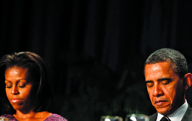 LARRY DOWNING / REUTERS Are you there, God? The Obamas at the National Prayer Breakfast, February 2012.