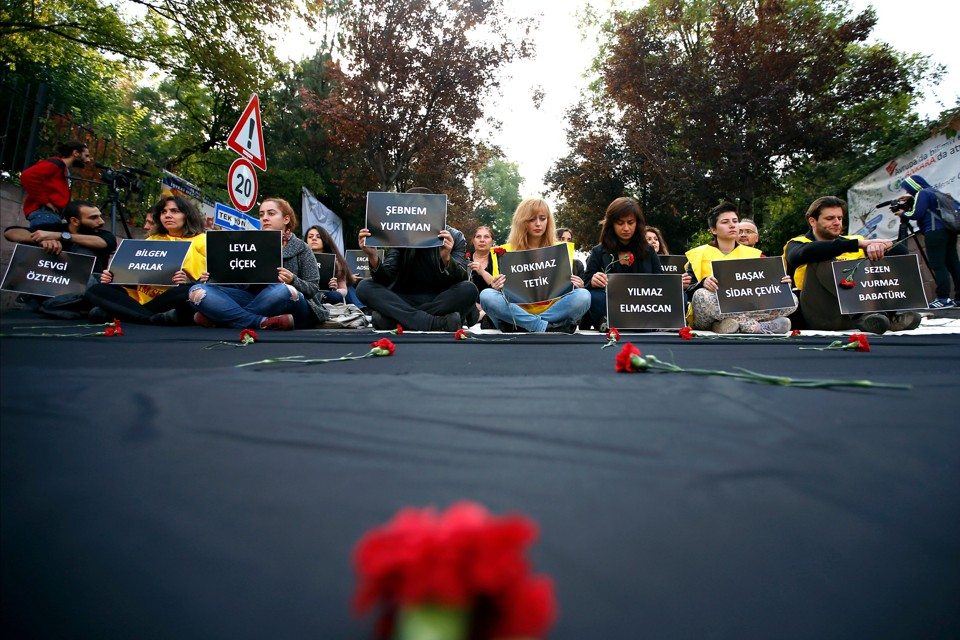 Students of Ankara University hold placards with the names of those killed in Saturday's deadly explosions during a sit-in protest in Ankara, Turkey, Tuesday, Oct. 13, 2015. Authorities in Istanbul banned a protest rally and march by the same trade union and civic society groups who lost friends and colleagues in Turkey's bloodiest terror attack. Dogan news agency video footage on Tuesday showed police pushing back dozens of demonstrators trying to reach the rally to commemorate the 97 victims of the twin suicide bombings. Some demonstrators were detained.(AP Photo/Emrah Gurel)